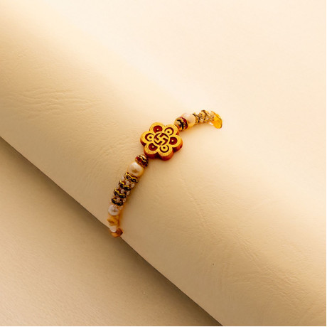 AD and Pearls Studded Swastik Rakhi
