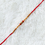 Beaded AD Charms Rakhi for Auspicious Tying Beaded AD Charms Rakhi for Auspicious Tying