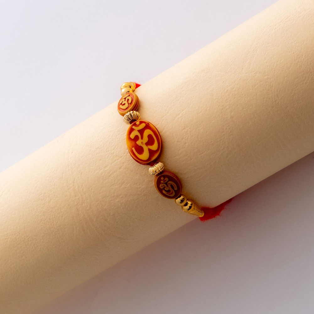 Beautiful OM Rakhi with Golden Beads Beautiful OM Rakhi with Golden Beads
