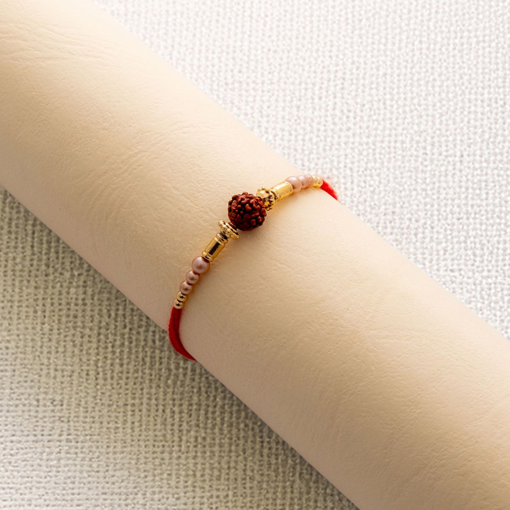 Beautiful Pearl Rakhi with Rudraksh Accent Beautiful Pearl Rakhi with Rudraksh Accent