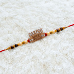 CARING BHAI Motif Rakhi Graced with Pearls, AD and Beads