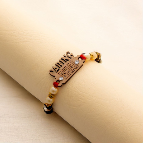 CARING BHAI Motif Rakhi Graced with Pearls, AD and Beads