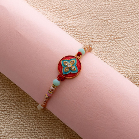 Elegant Enamel Rakhi with Sparkling Diamonds Elegant Enamel Rakhi with Sparkling Diamonds