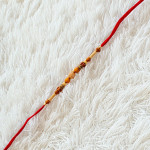 Gleaming Pearl Rakhi with Fancy Beads Gleaming Pearl Rakhi with Fancy Beads