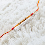 Golden and Red Beads Work Fancy Rakhi Golden and Red Beads Work Fancy Rakhi