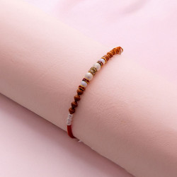 Gorgeous Pearl Rakhi with American Diamonds and Beads Gorgeous Pearl Rakhi with American Diamonds and Beads