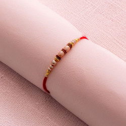 Gorgeous Pearl Rakhi with Golden Beads