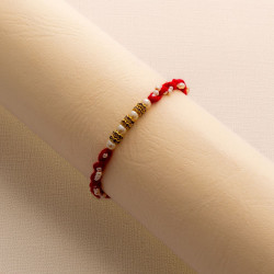 Handcrafted Pearl Rakhi with AD Charms Details Handcrafted Pearl Rakhi with AD Charms Details