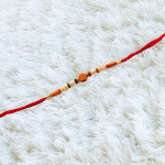 Handcrafted Pearls Rakhi with OM Centrepiece
