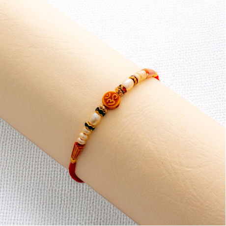 Handcrafted Pearls Rakhi with OM Centrepiece