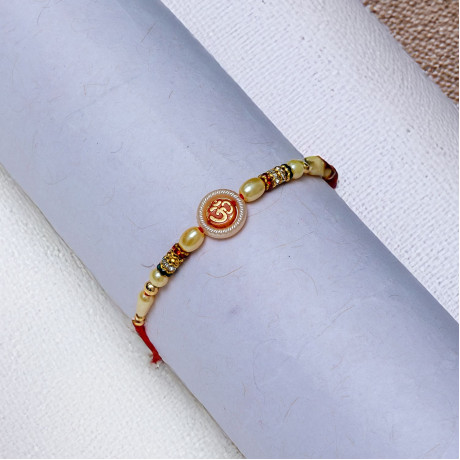 Lustrous OM Pearls Rakhi