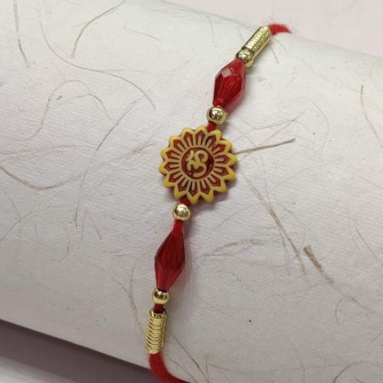 OM Rakhi with Red and Golden Beads