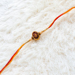 OM with Pearls and Golden Beads Rakhi OM with Pearls and Golden Beads Rakhi