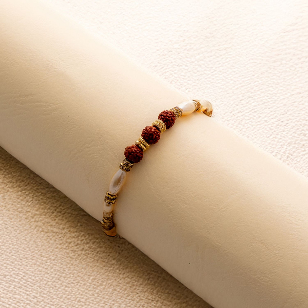 Pearls with Triple Rudraksha Traditional Rakhi Pearls with Triple Rudraksha Traditional Rakhi