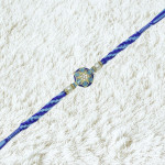 Royal Blue Rakhi with Elegant Pearls Embellishments Royal Blue Rakhi with Elegant Pearls Embellishments