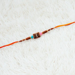 Rustic Beads Rakhi with Shining Diamonds and Enamel Work Rustic Beads Rakhi with Shining Diamonds and Enamel Work