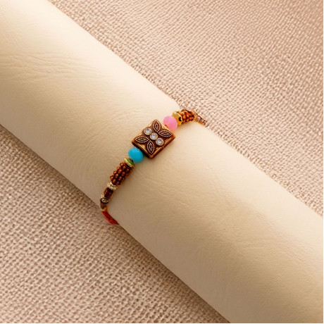 Rustic Beads Rakhi with Shining Diamonds and Enamel Work Rustic Beads Rakhi with Shining Diamonds and Enamel Work