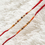 Stylish Set of 2 Rakhis with Pearls and AD Charms Stylish Set of 2 Rakhis with Pearls and AD Charms