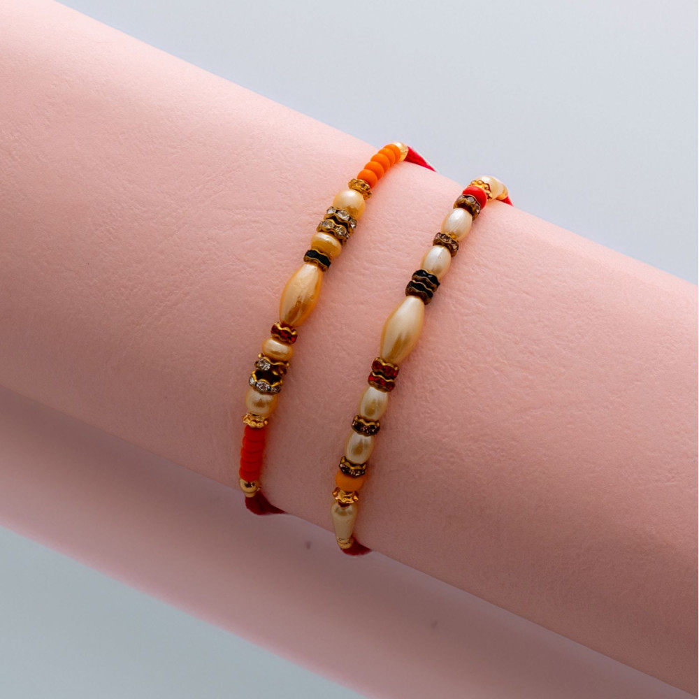 Stylish Set of 2 Rakhis with Pearls and AD Charms Stylish Set of 2 Rakhis with Pearls and AD Charms