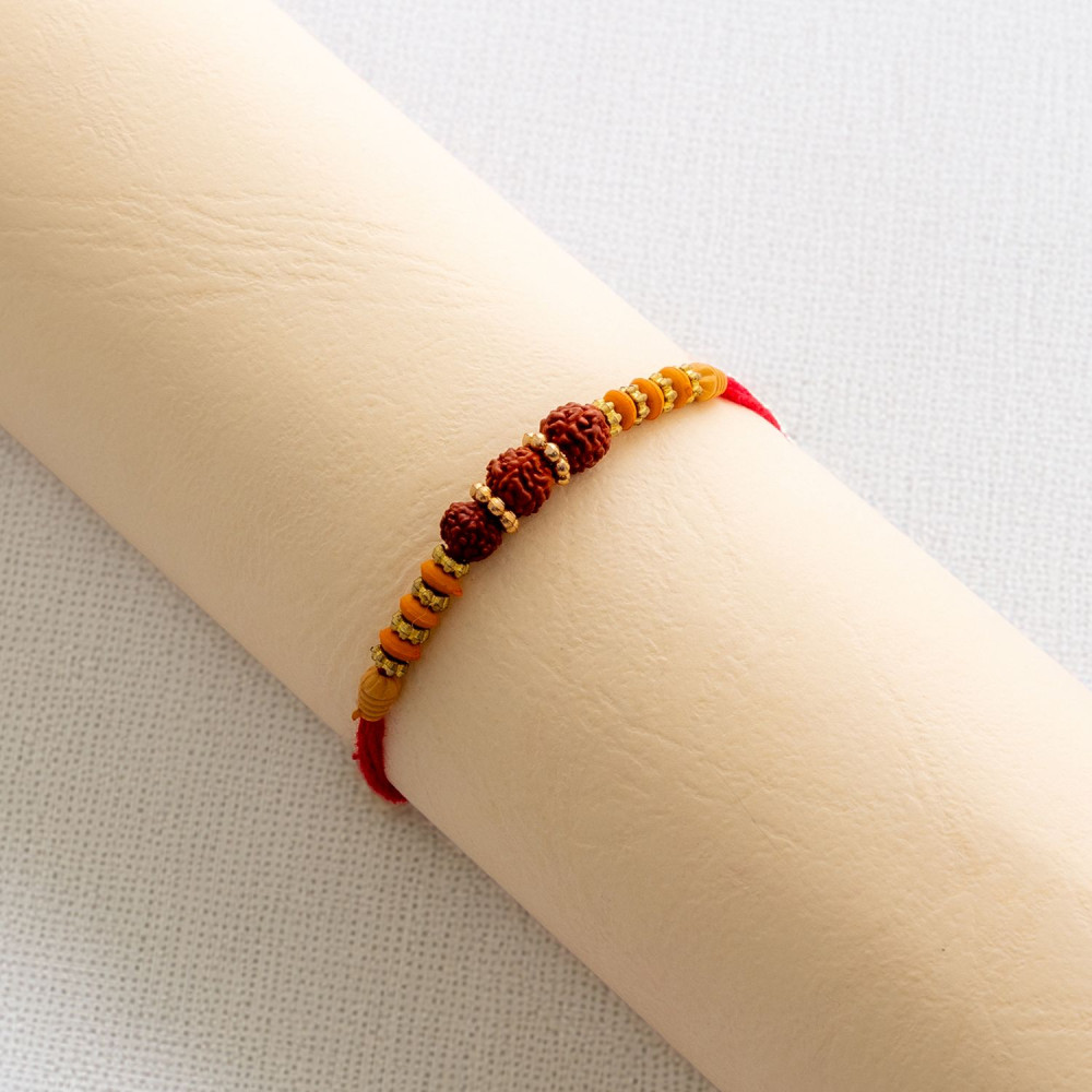 Triple Rudraksha Rakhi with Beads Triple Rudraksha Rakhi with Beads