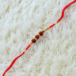 Triple Rudraksha Rakhi with Colorful Beads Triple Rudraksha Rakhi with Colorful Beads