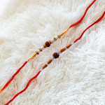 Vibrant Set of 2 Rakhis with Pearls and Rudraksh Vibrant Set of 2 Rakhis with Pearls and Rudraksh
